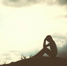 Silhouette Of A Person Thinking Sitting On Ground With Sky Above